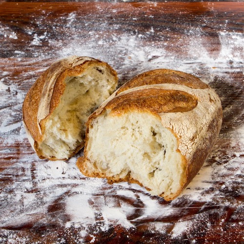 Bread on a floured table at The Kitchen at Middleground Farms