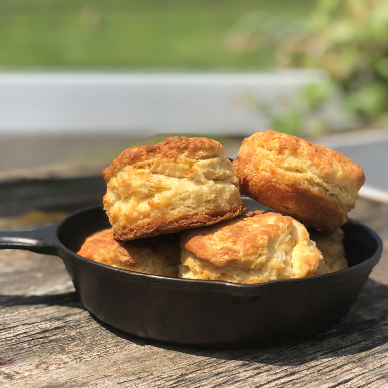 A pan full of beautiful biscuits on a picnic table at The Kitchen at Middleground Farms