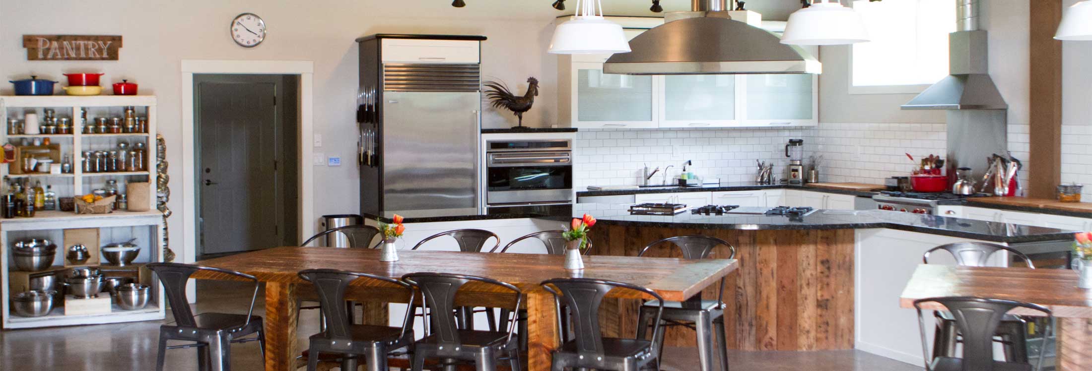 The cooking kitchen and barnwood tables at The Kitchen at Middleground Farms