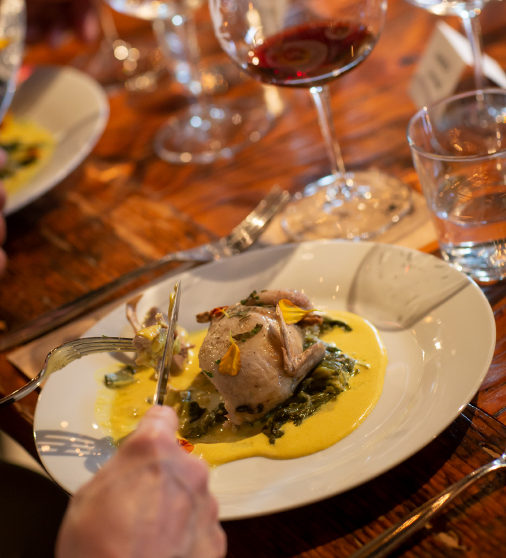 A guest enjoys a plated entree during a private dinner at The Kitchen at Middleground Farms