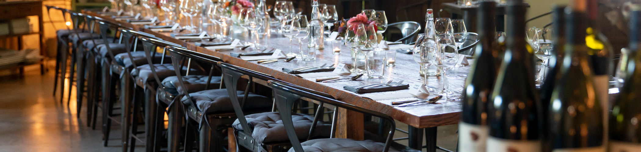 A barnwood table at The Kitchen at Middleground Farms set for a private event.
