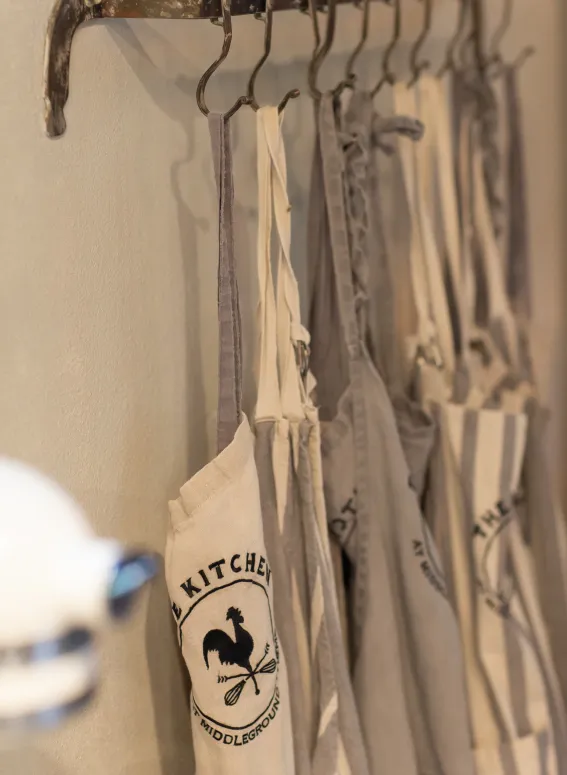 Guest aprons hanging in The Kitchen at Middleground Farms